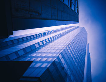 Low angle view of modern building against blue sky