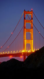 Low angle view of suspension bridge against sky