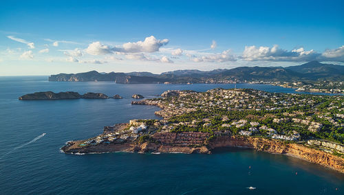 High angle view of townscape by sea against sky