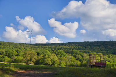 Windmill on field against sky