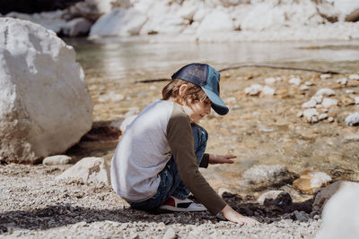 Rear view of woman sitting on beach