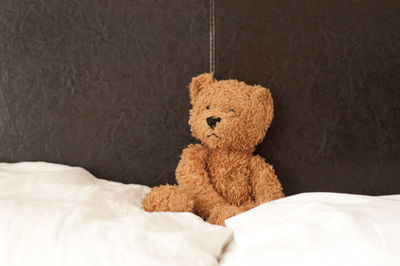 Teddy bear on bed at home