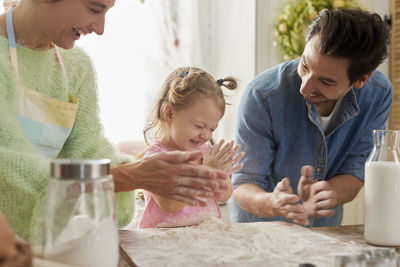 Family preparing food in kitchen