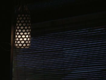 Low angle view of illuminated electric lights on ceiling