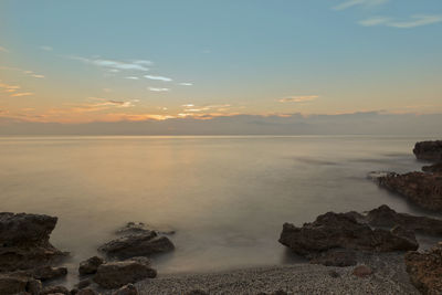 Scenic view of sea against sky at sunset