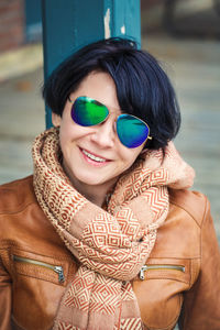 Woman wearing sunglasses sitting outdoors