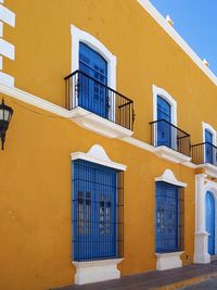 Low angle view of yellow windows on building