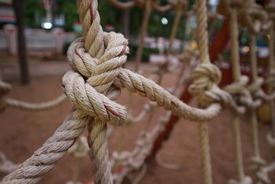 Close-up of rope tied to wooden post