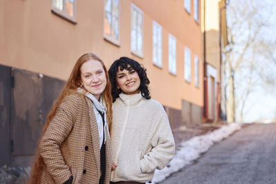 Portrait of smiling young women in street