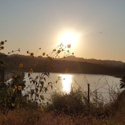 Scenic view of lake against sky during sunset