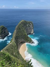 High angle view of rocks in sea against sky