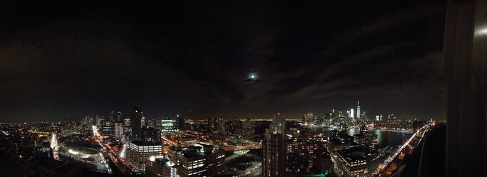 Illuminated cityscape against sky at night