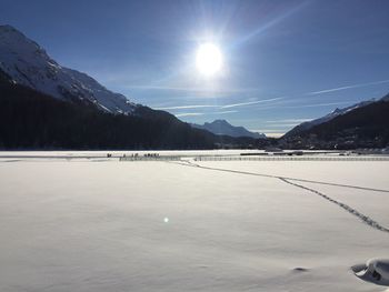 Scenic view of snow covered mountains against sky