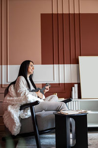 Young woman using laptop while sitting at home