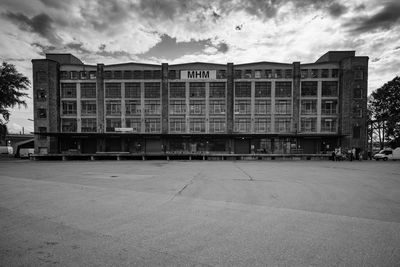 Building by street against sky