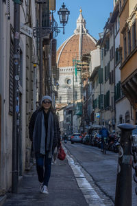 Portrait of woman walking on street in city