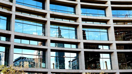 Reflection of cityscape on glass building