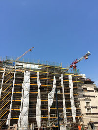 Low angle view of built structure against clear blue sky