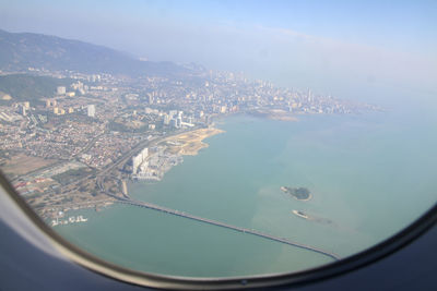 Aerial view of sea and buildings in city