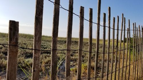 View of barbed wire fence on field