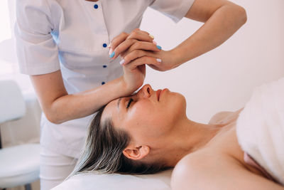 Cosmetologist does facial massage for woman. beauty skin care