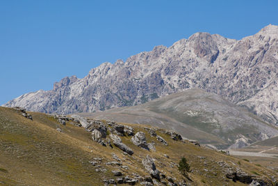 Scenic view of mountains against clear blue sky