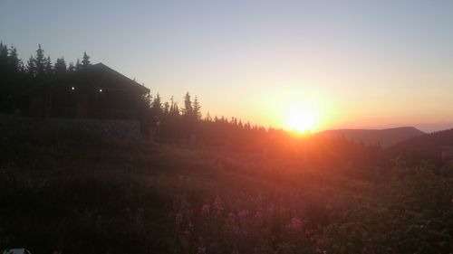 Scenic view of field against sky during sunset