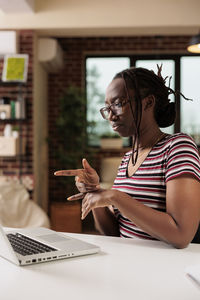 Young woman using laptop at home