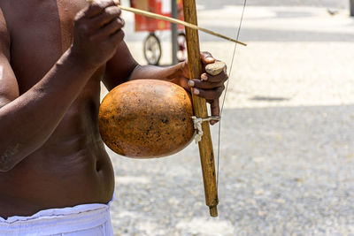 Musicians playing traditional instruments used in capoeira in pelourinho street in salvador, bahia