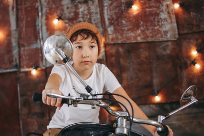 Full length of boy holding bicycle