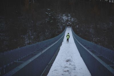 Man on road amidst trees