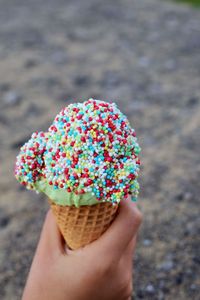 Close-up of hand holding ice cream cone