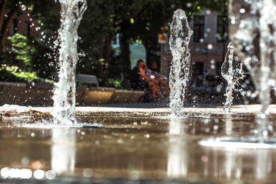 Water fountain in swimming pool at park