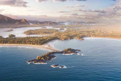 Aerial view of sea and mountains against sky