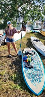 Full length of boy standing by tree