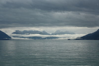 Scenic view of sea and mountains against sky