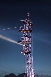 Low angle view of tower against sky at night