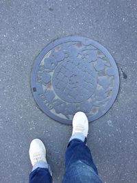 Low section of man standing on street