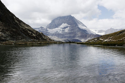 Scenic view of lake and mountains against sky