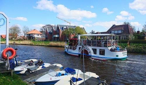 View of boats in city against sky