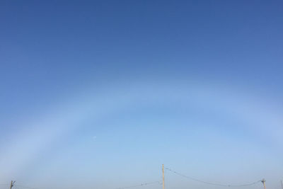 Low angle view of cables against clear blue sky