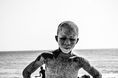 Portrait of man on beach against clear sky