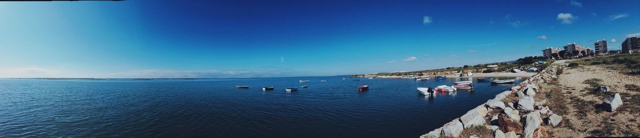 sea, water, sky, blue, horizon over water, scenics, tranquil scene, tranquility, nautical vessel, transportation, beauty in nature, waterfront, nature, incidental people, boat, panoramic, mode of transport, idyllic, day, sunlight