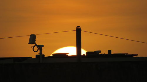 Low angle view of silhouette bridge against sky during sunset