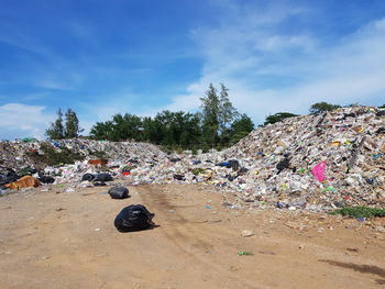 Garbage bin on land against sky