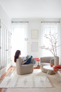 Woman reading in light-filled living space