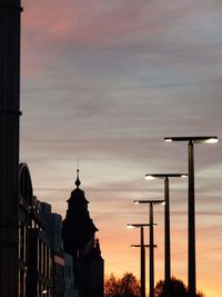 High section of silhouette church against orange sky