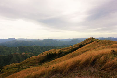 Scenic view of mountain against cloudy sky