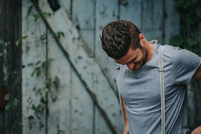 Full length of young man standing against wall