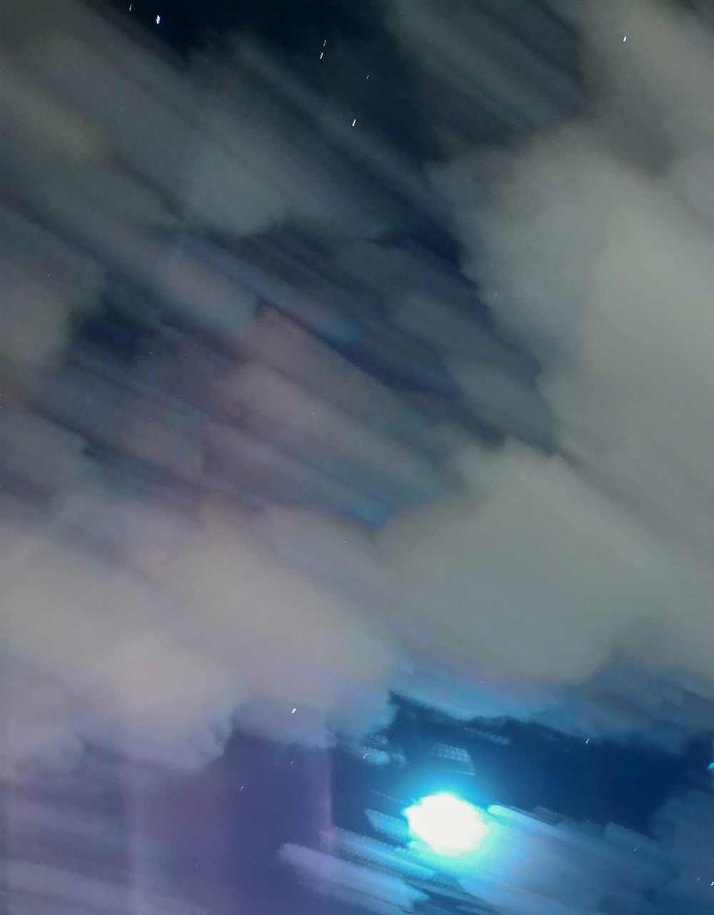 LOW ANGLE VIEW OF ILLUMINATED BUILDING AT NIGHT